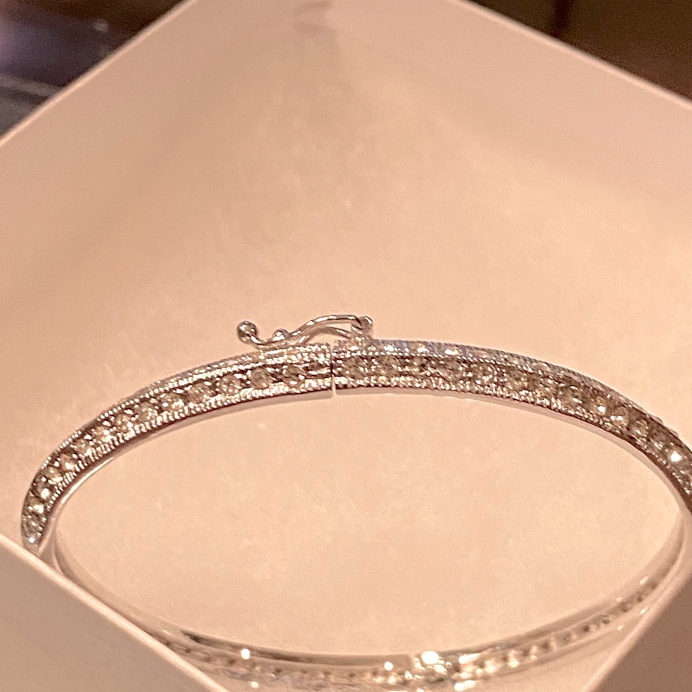 Silver bracelet with pave set cz’s. Hinge opening with safety clasp.